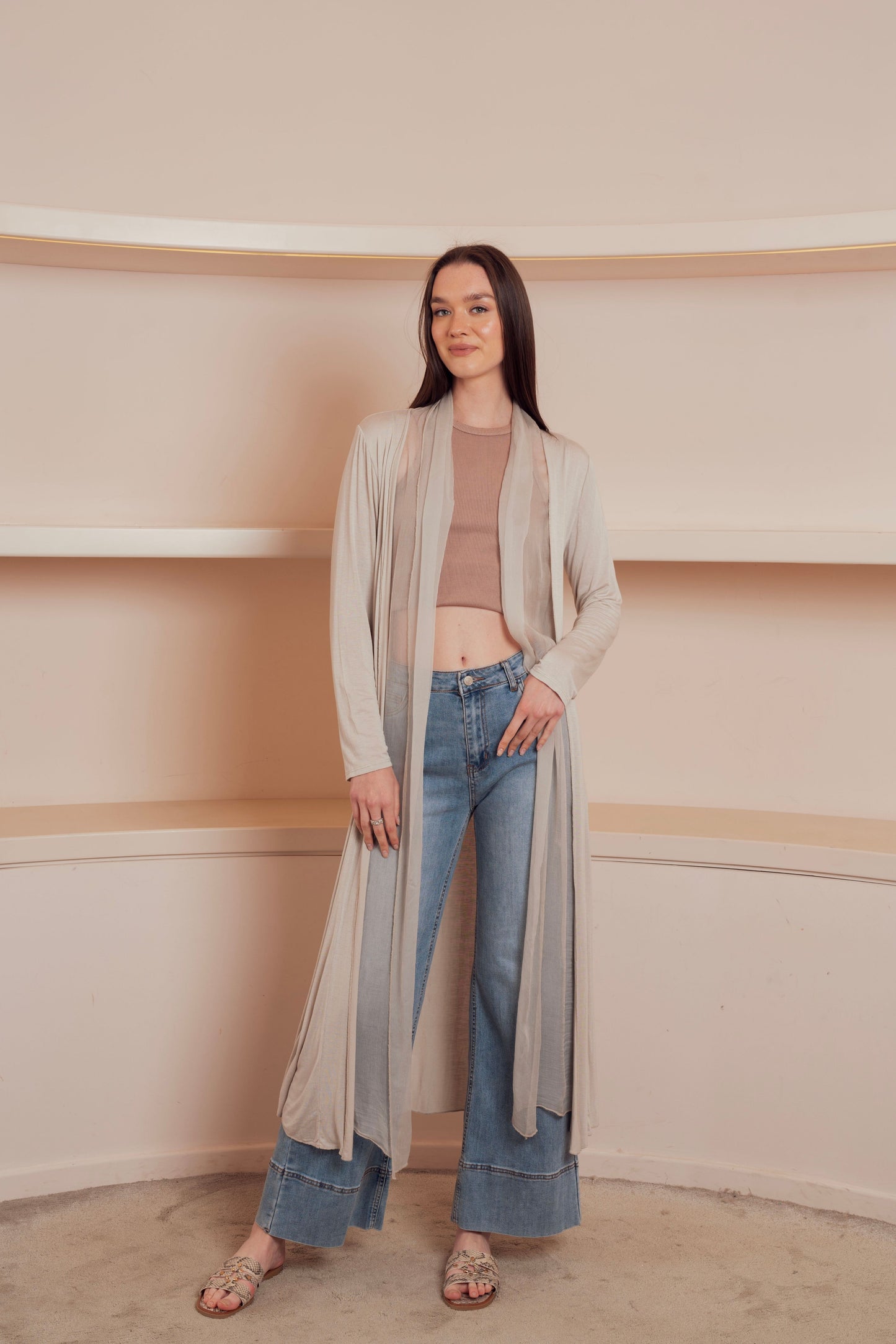 a long, flowing, light beige cardigan