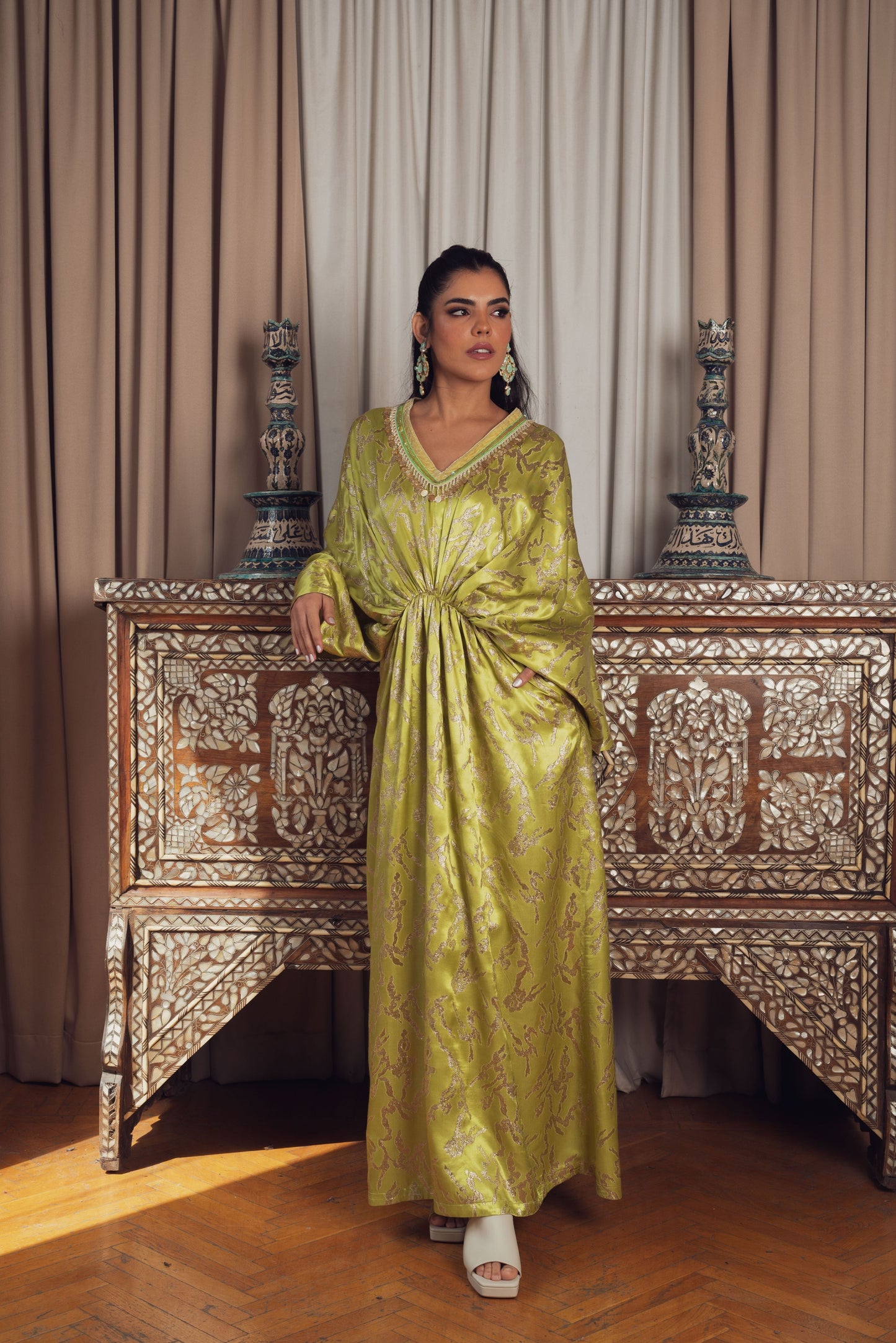 A stunning, gold-embroidered kaftan with flowing sleeves
