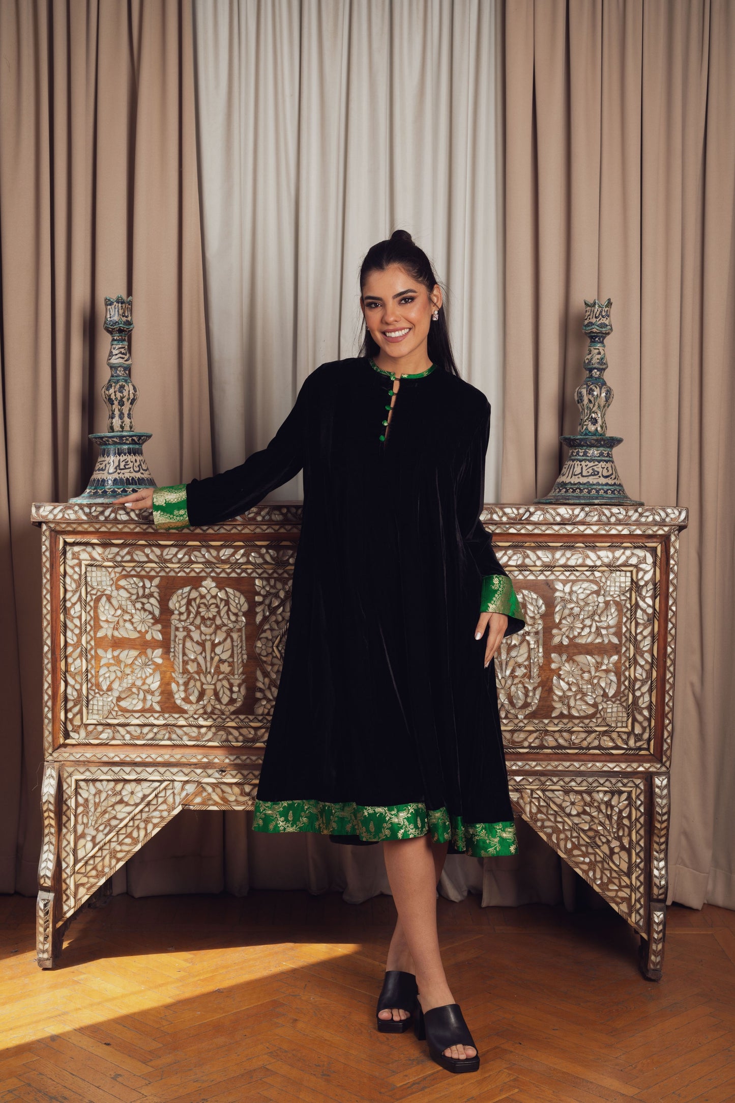 A timeless black velvet kaftan featuring intricate gold and Green