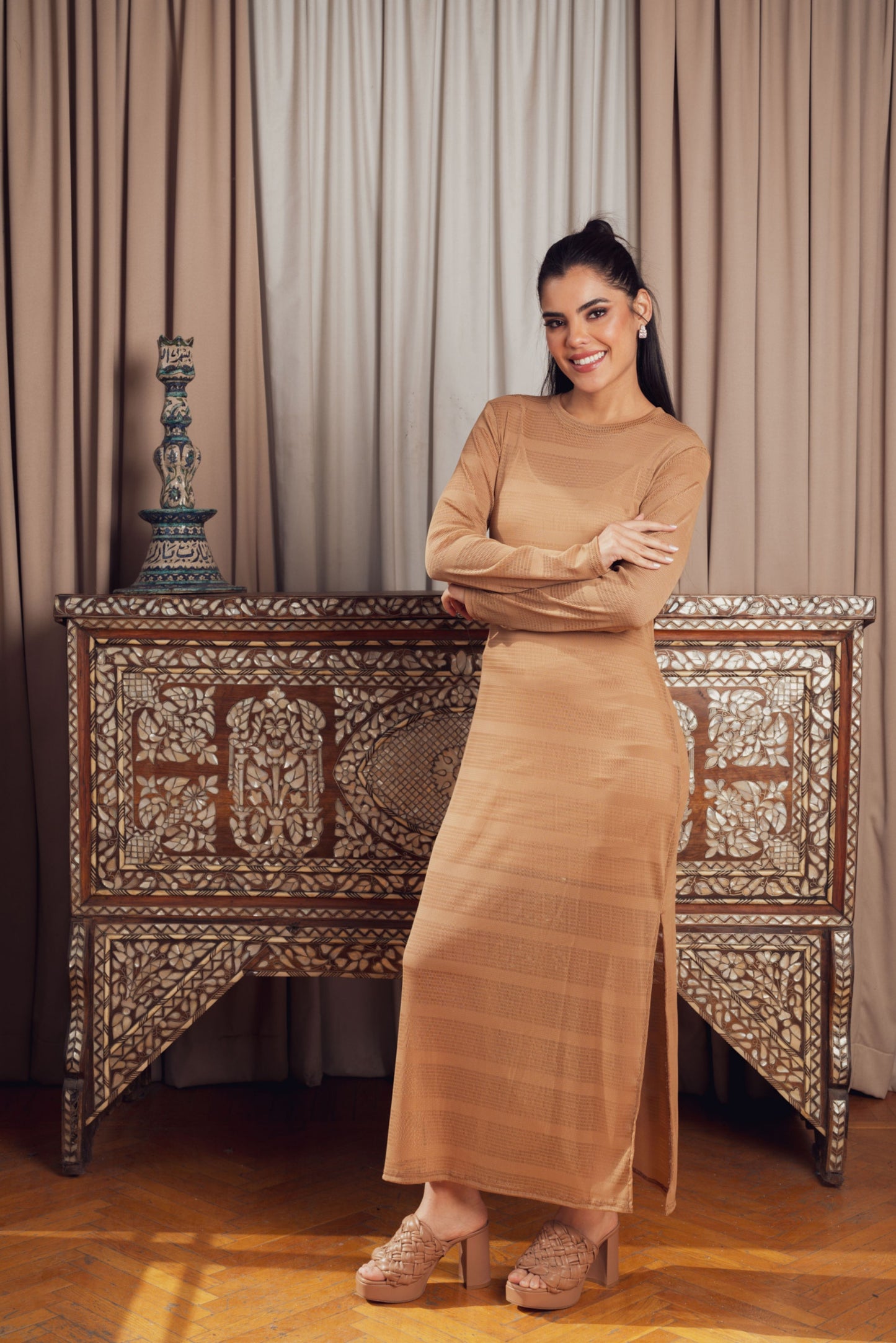 A sleek, long-sleeve maxi dress in a warm beige