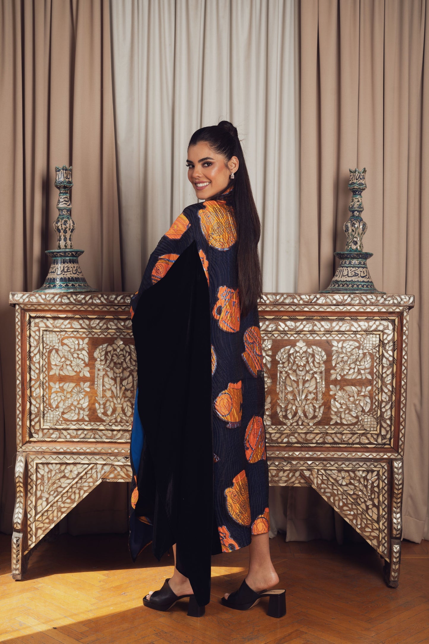 A striking black kaftan with bold orange