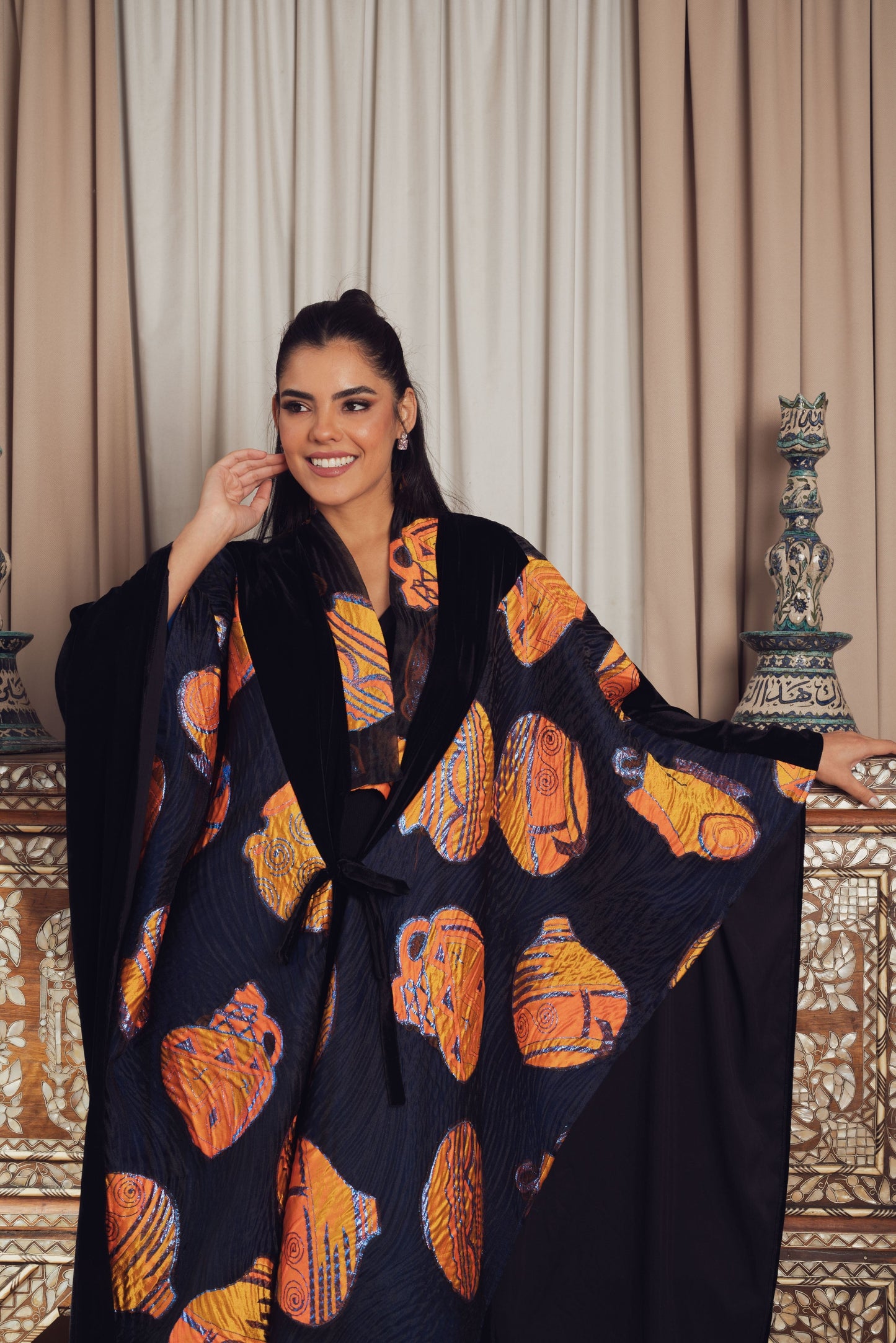 A striking black kaftan with bold orange