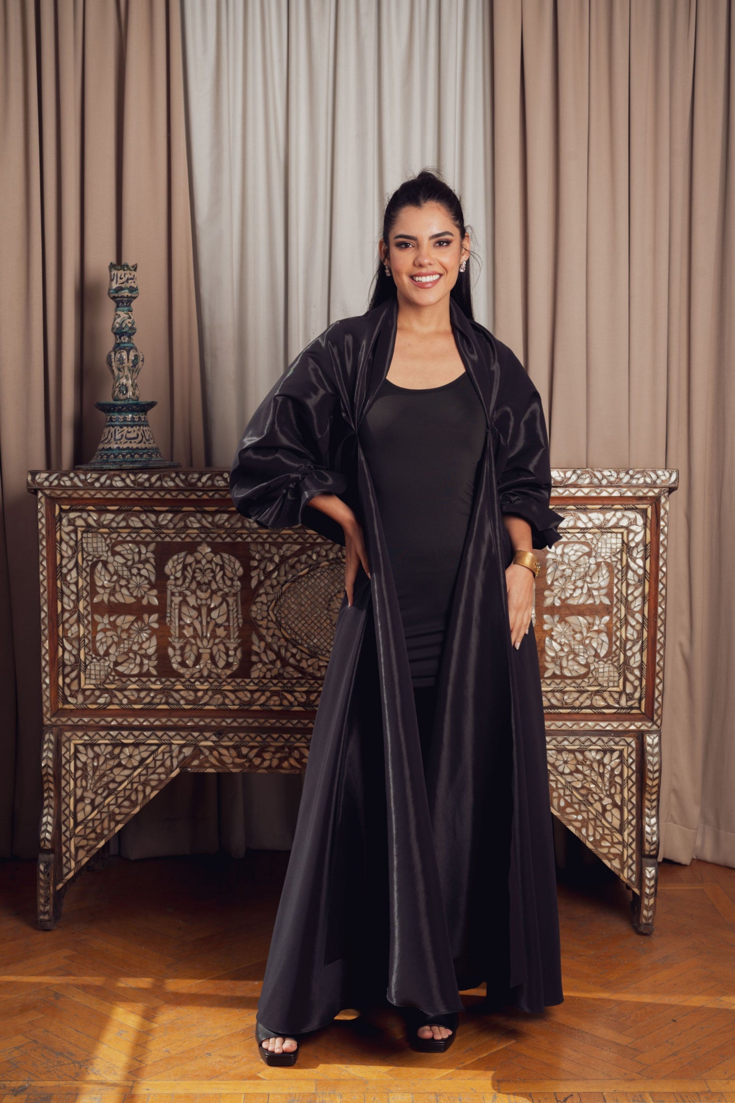 n elegant black ensemble featuring a fitted black kaftan