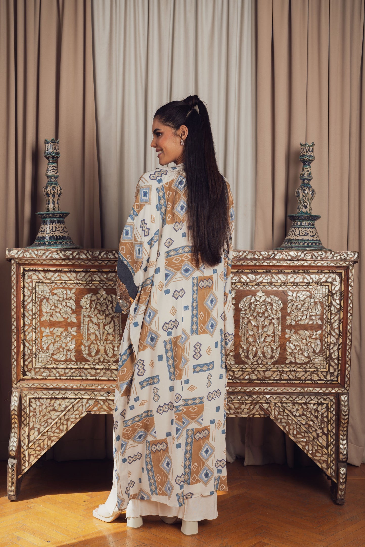 A stylish open-front kaftan featuring a geometric print in earthy tones