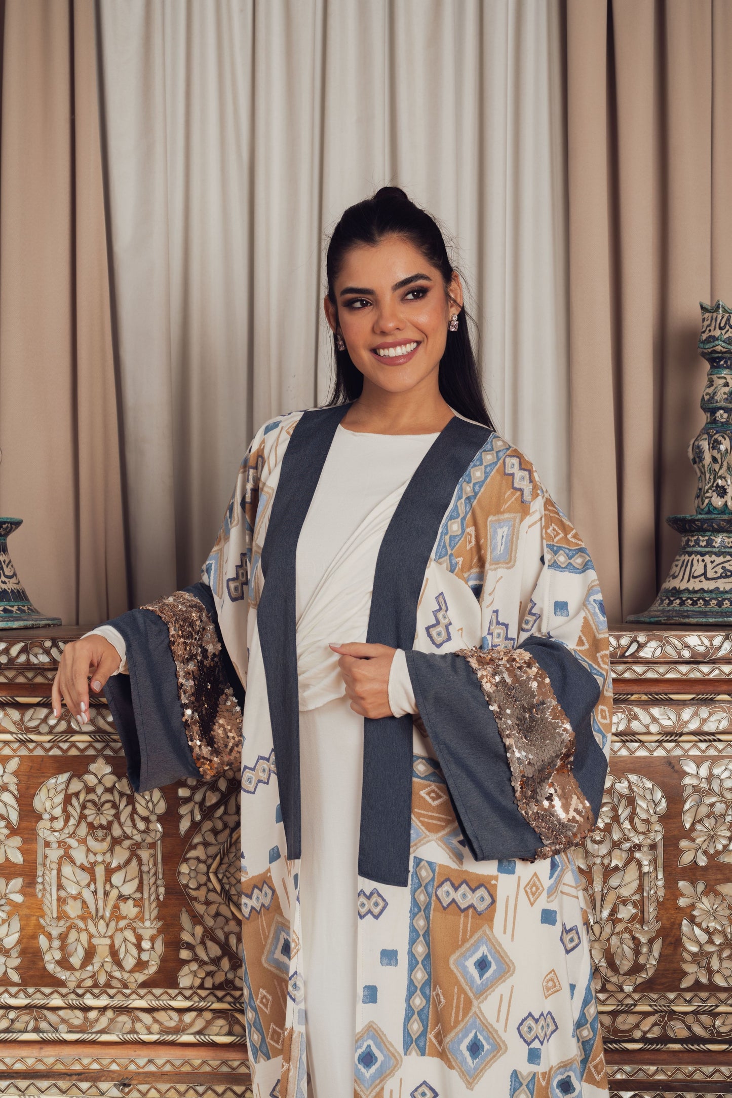A stylish open-front kaftan featuring a geometric print in earthy tones