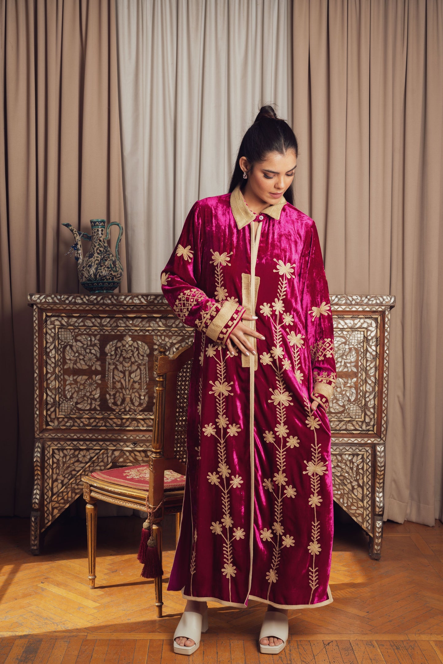 A rich fuchsia velvet kaftan adorned