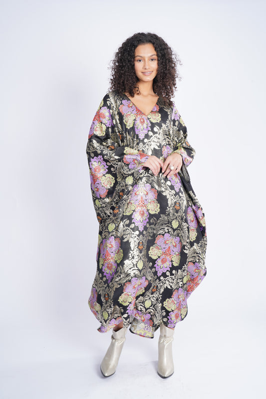A dress made of silk, with a wide cut and a belt at the bottom of the chest
