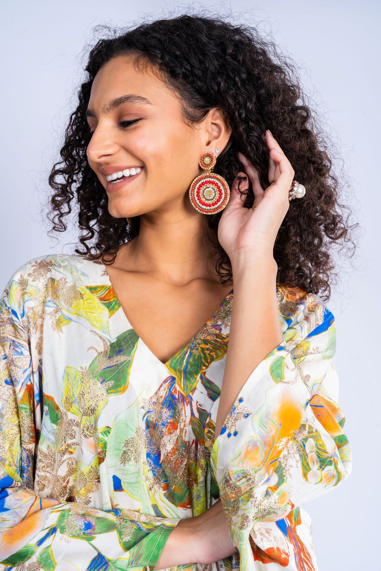 A dress made of silk, with a wide cut and a print in a variety of colors.