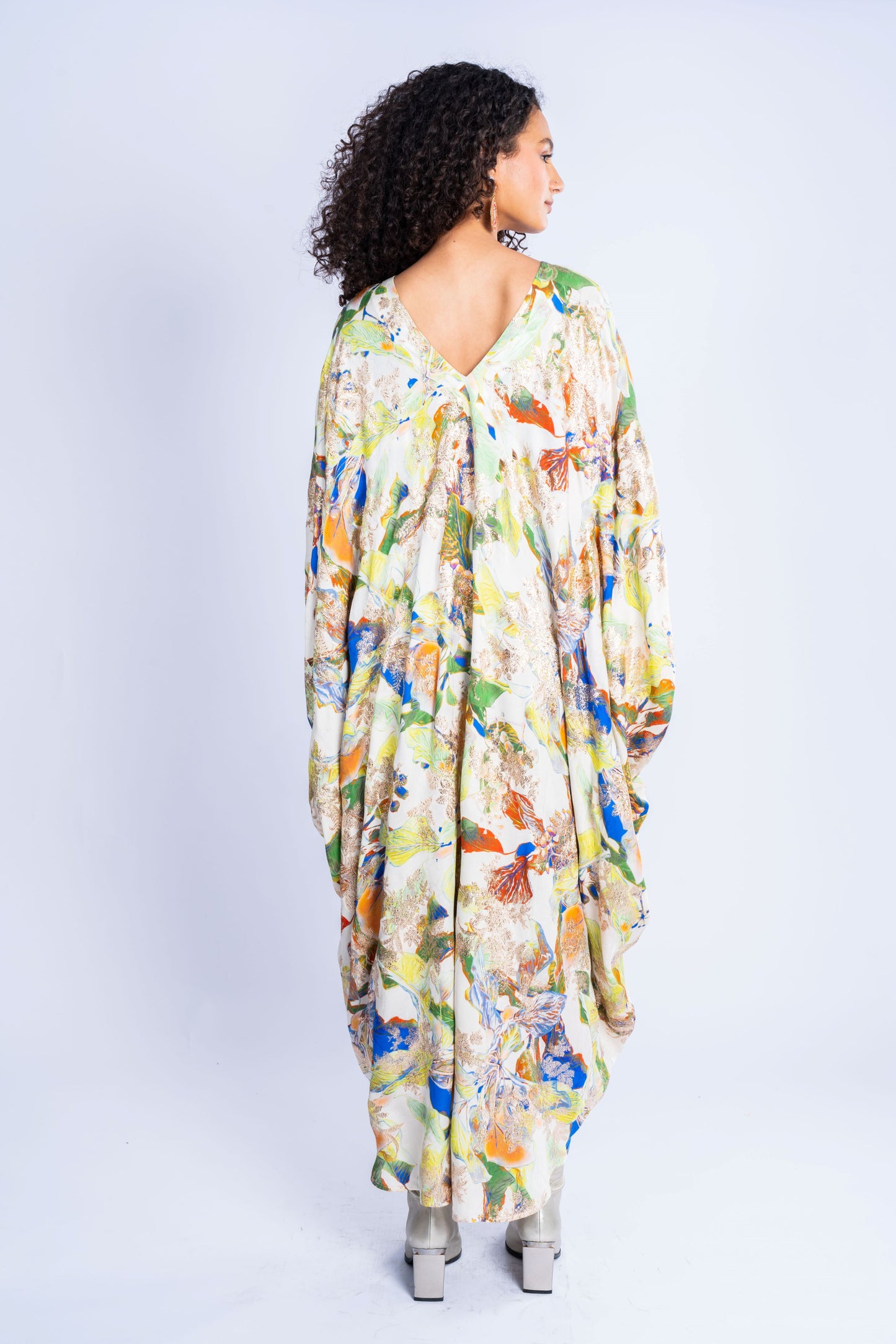 A dress made of silk, with a wide cut and a print in a variety of colors.