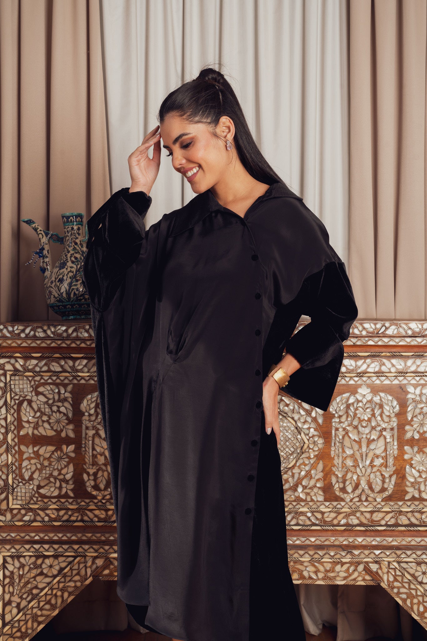 A black asymmetrical dress with a loose fit