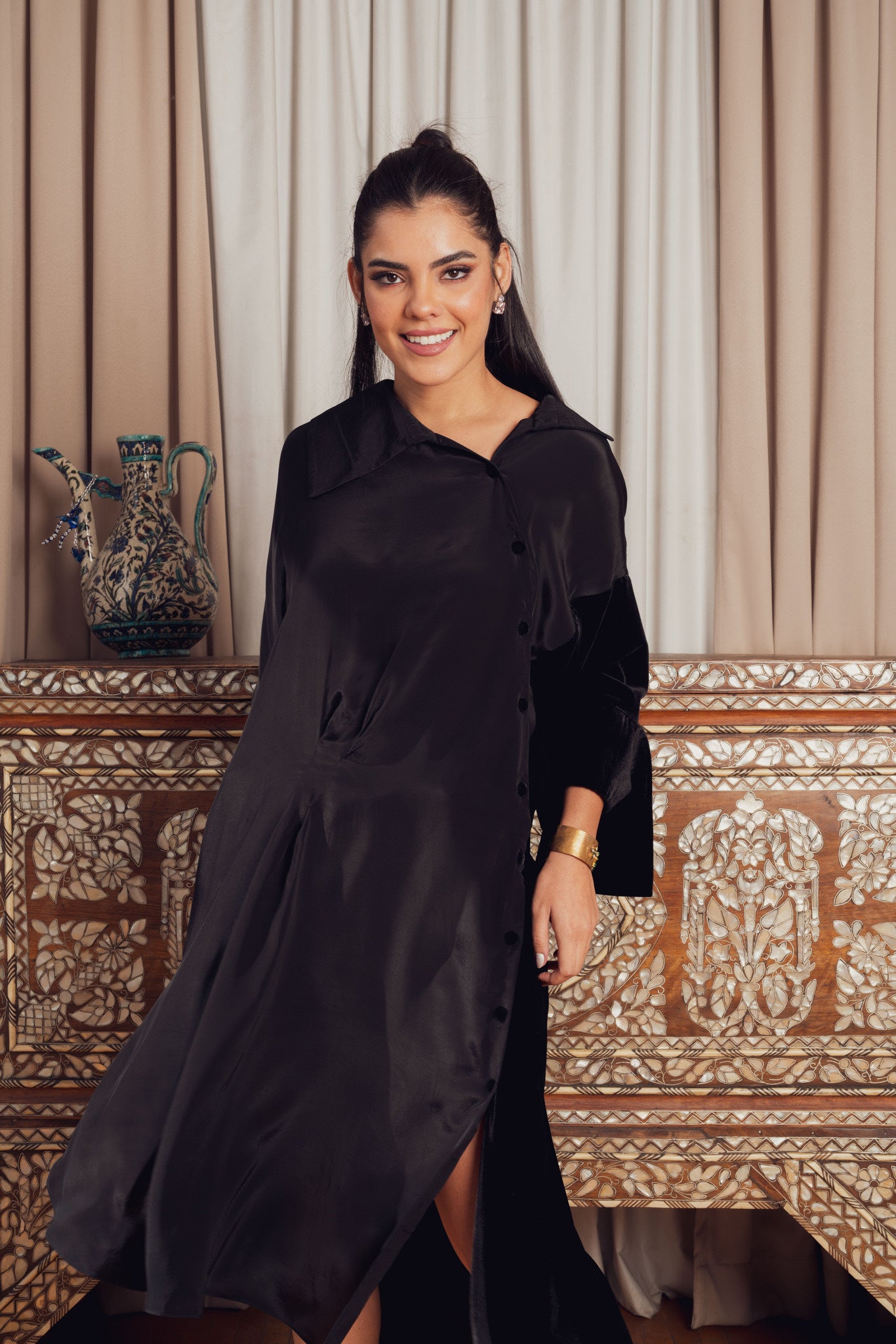 A black asymmetrical dress with a loose fit
