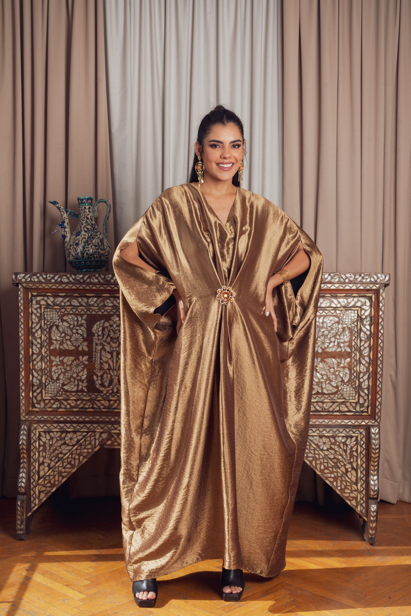 A luxurious gold kaftan with wide sleeves