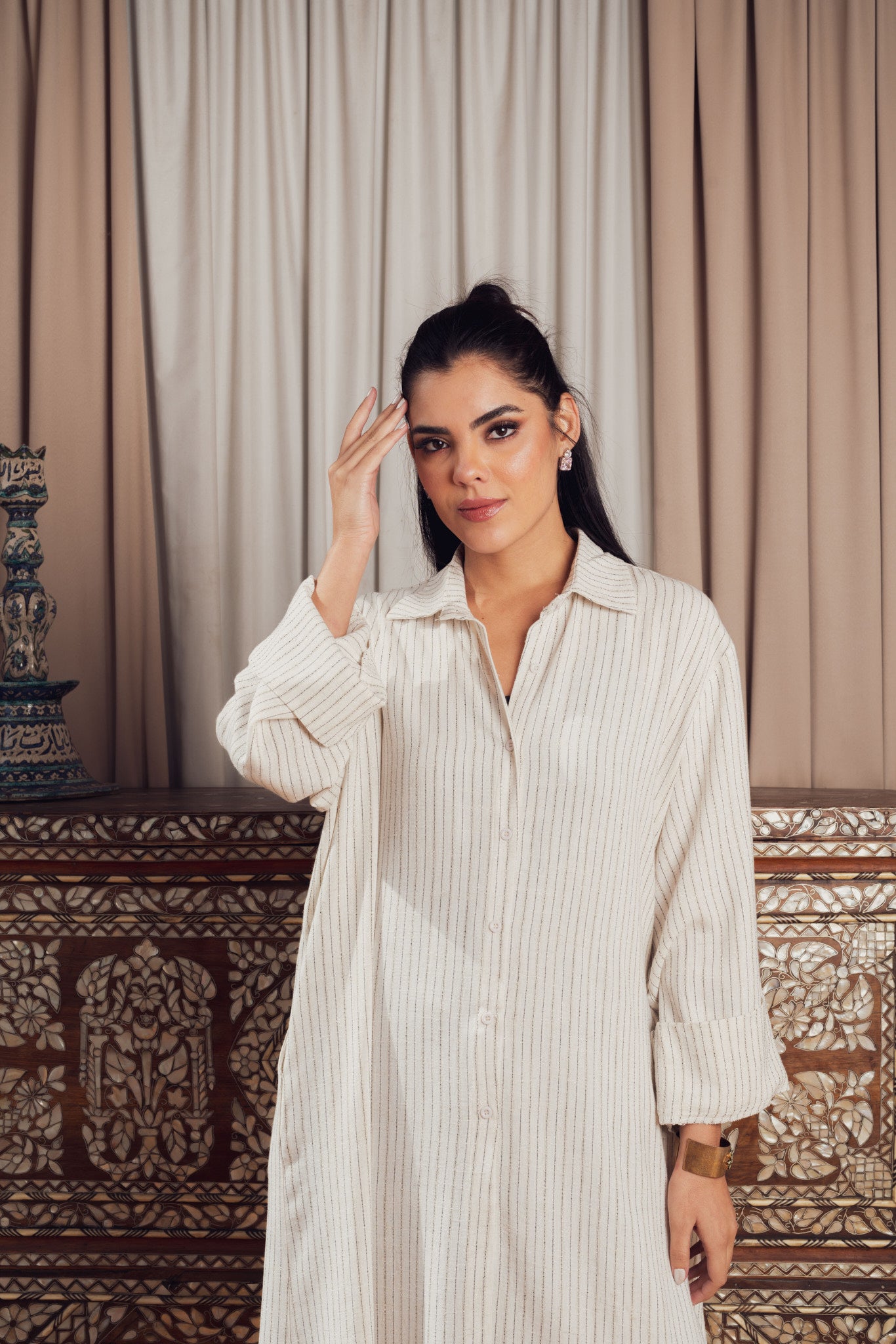 A long cream-colored striped shirt dress with a loose fit