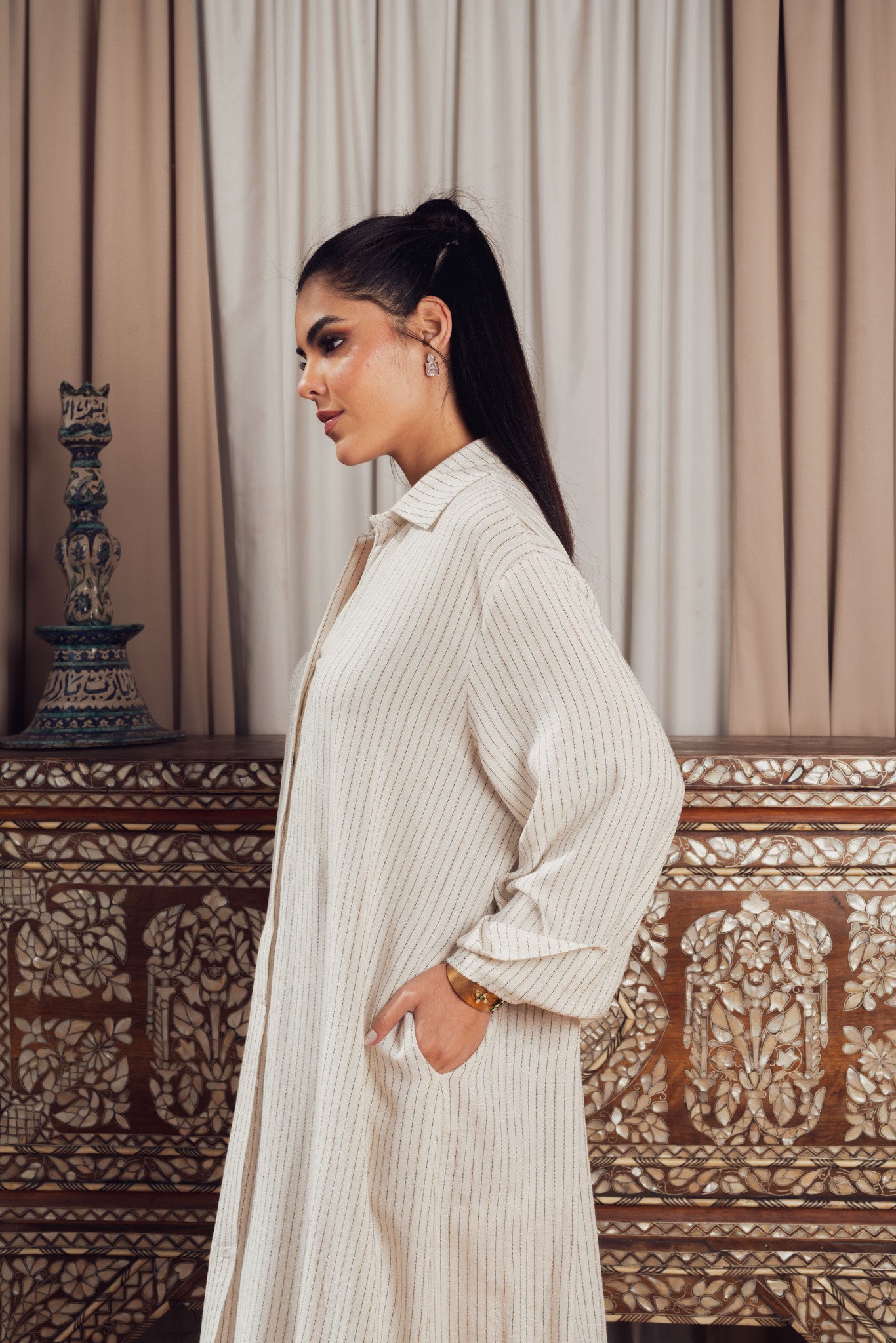 A long cream-colored striped shirt dress with a loose fit
