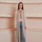 a long, flowing, light beige cardigan