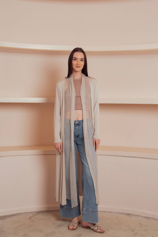 a long, flowing, light beige cardigan