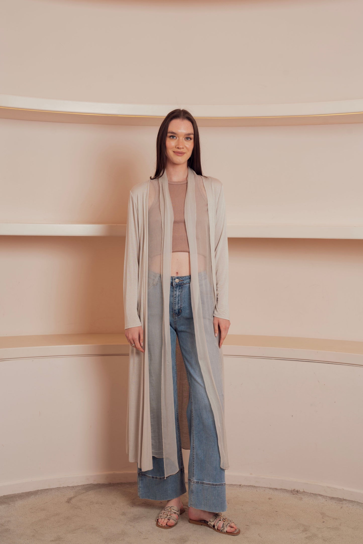 a long, flowing, light beige cardigan