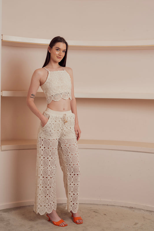 Beige crochet wide-leg pants with drawstring waist.