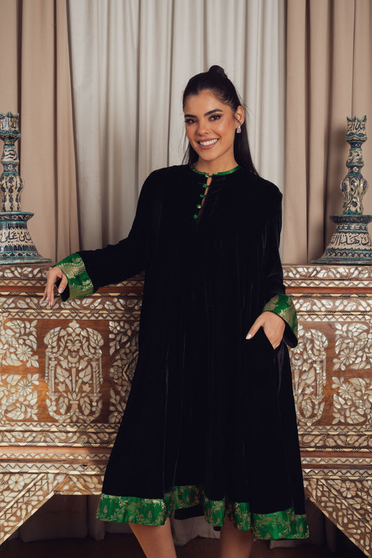 A timeless black velvet kaftan featuring intricate gold and Green