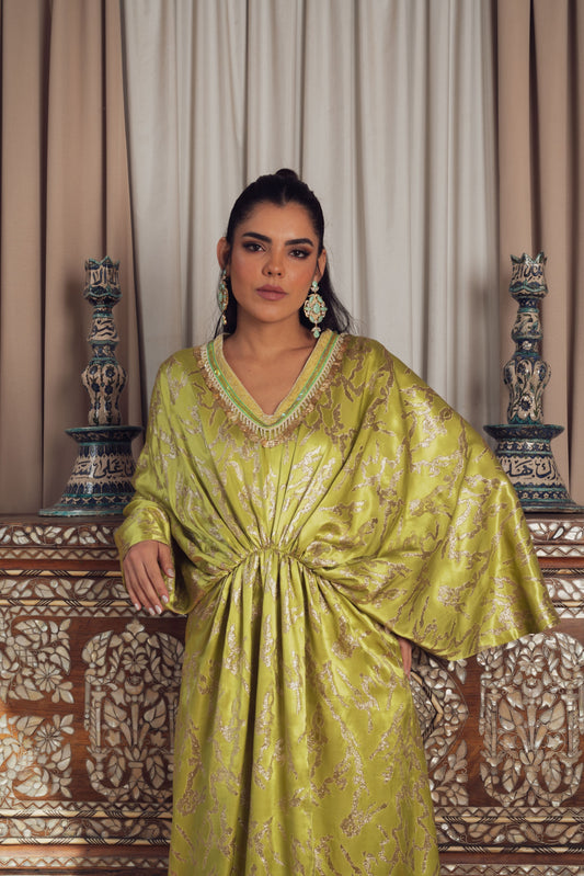 A stunning, gold-embroidered kaftan with flowing sleeves