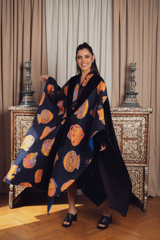 A striking black kaftan with bold orange