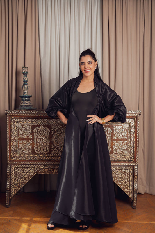 n elegant black ensemble featuring a fitted black kaftan