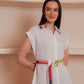 White button-down midi dress with colorful embroidered belt and collar accents.