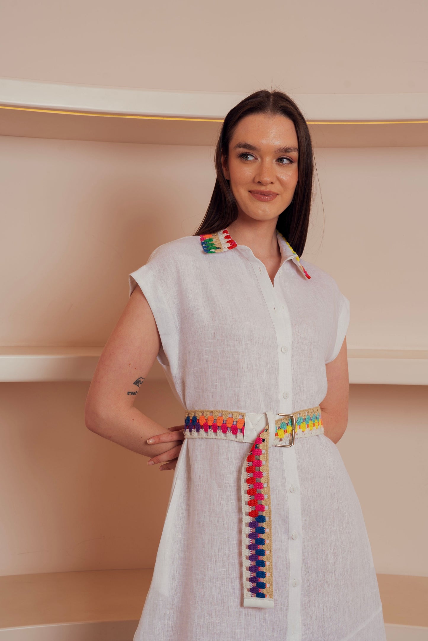 White button-down midi dress with colorful embroidered belt and collar accents.