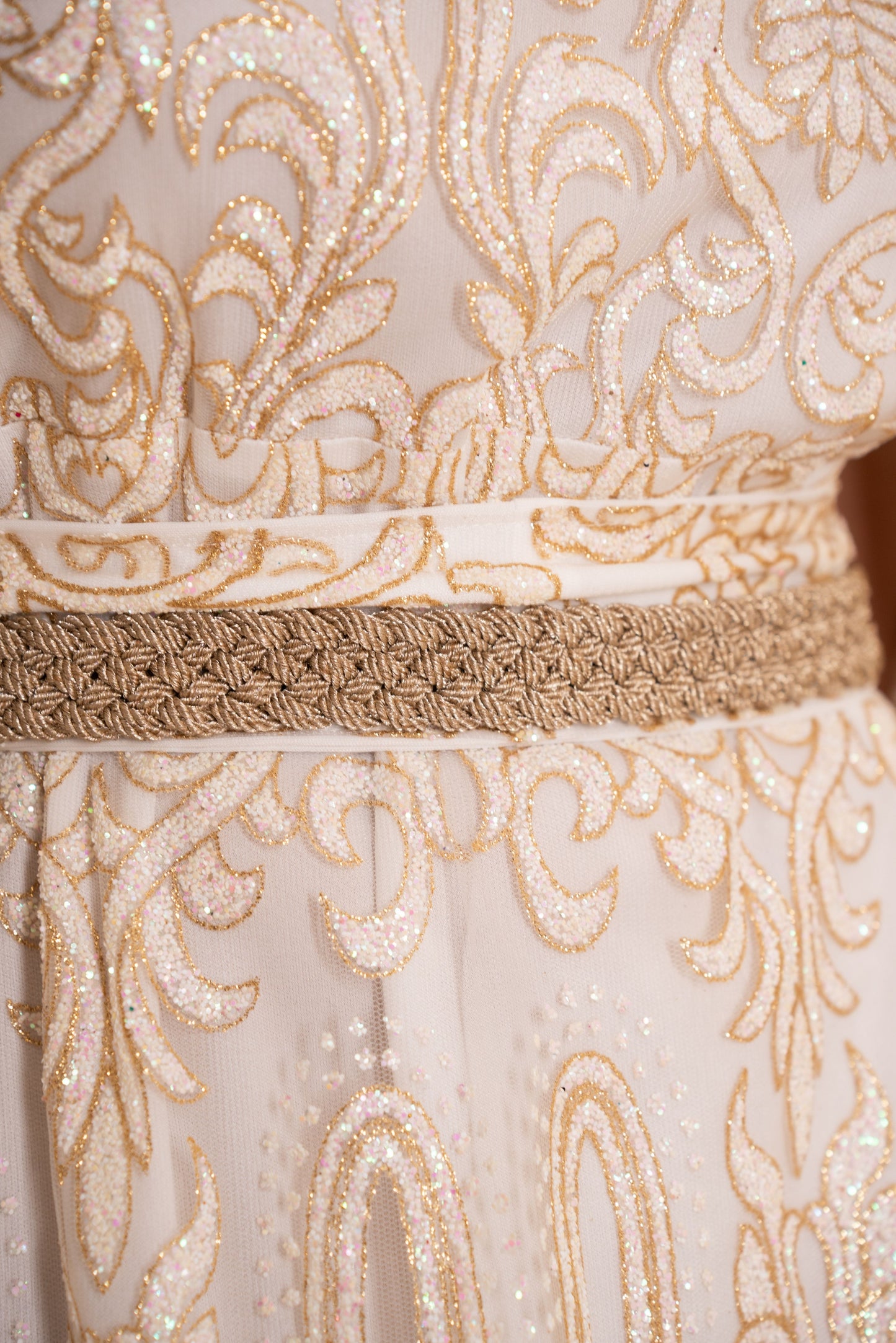 An elegant white and gold embroidered kaftan with a hood
