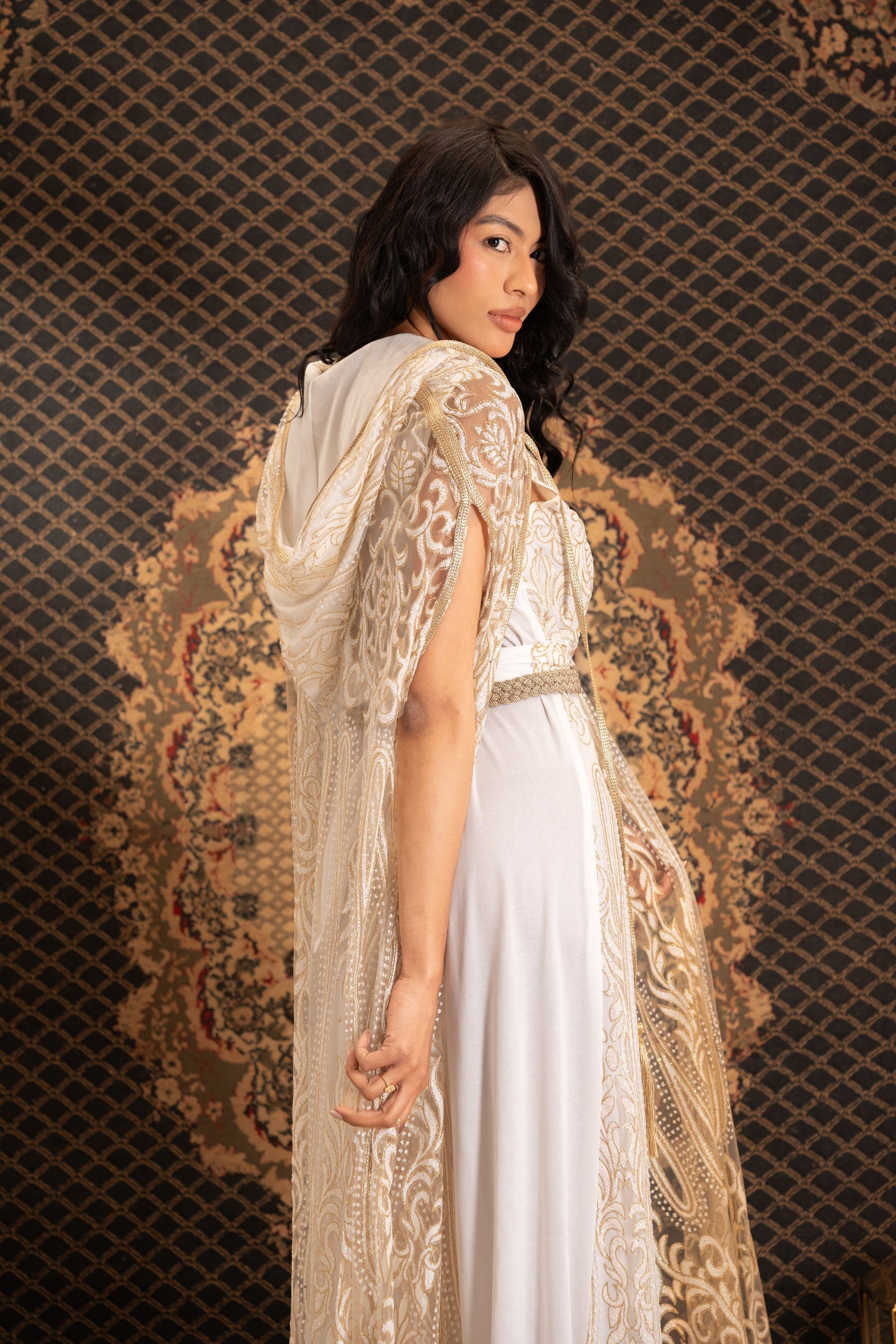 An elegant white and gold embroidered kaftan with a hood