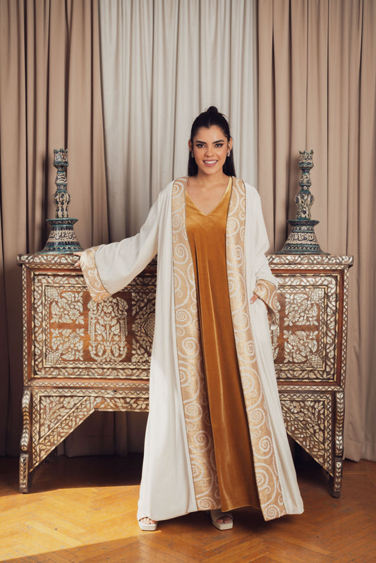 A luxurious white abaya with intricate gold