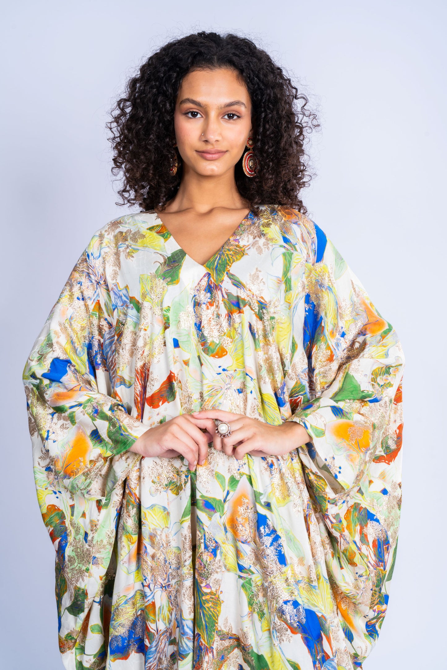 A dress made of silk, with a wide cut and a print in a variety of colors.