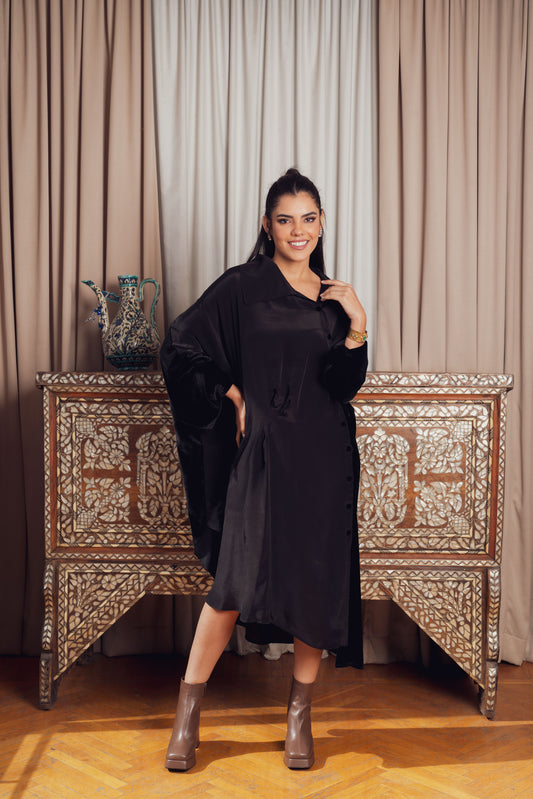 A black asymmetrical dress with a loose fit