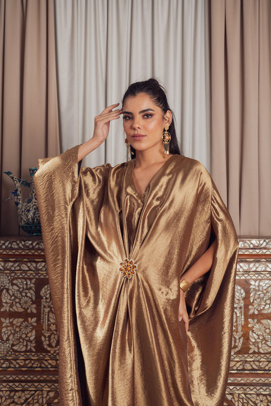 A luxurious gold kaftan with wide sleeves