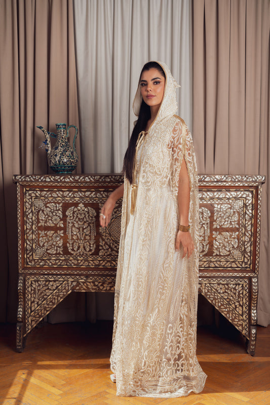 An elegant white and gold embroidered kaftan with a hood