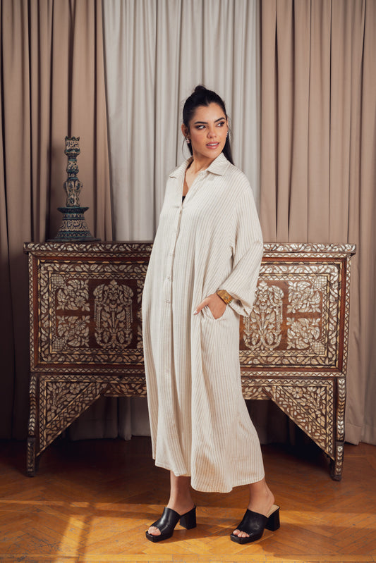 A long cream-colored striped shirt dress with a loose fit